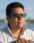Man, 40, wearing Peppers Gaucho sunglasses in Shiny Tort with G15 Lens, at a shallow inlet