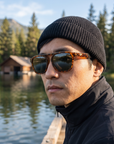 Man, 33, wearing Peppers Milano sunglasses in Shiny Caramel Tort Frame with G15 Lens, on a mountain-lake dock