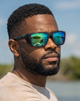 Man, 31, wearing Peppers Sea Dweller 2.0 sunglasses in Matte Dark Green / Silver Frame with Green Diamond Mirror Lens, on the flats