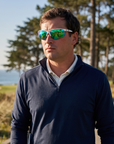 Man, 34, wearing Peppers Three Wood sunglasses in Matte White Frame with Green Revo PC Lens, on a coastal golf course