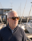 Man, 54, wearing Peppers Cascade sunglasses in Black to Transparent Yellow Frame with Tea Lens, on a marina walkway