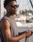 Man, 26, wearing Peppers Chilmark sunglasses in Shiny Black Frame with Smoke Lens, on a marina dock