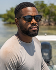 Man, 31, wearing Peppers Cool Breeze sunglasses in Shiny Black Fade to Shiny Tortoise with Smoke, on the flats