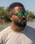 Man, 31, wearing Peppers Daybreak sunglasses in Shiny Green Striped Tort Frame with Green Mirror Lens, on the flats
