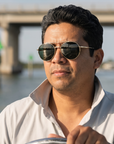 Man, 40, wearing Peppers Django sunglasses in Gold Frame with G-15 Lens, at a shallow inlet