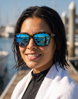 Woman, 25, wearing Peppers Gaucho sunglasses in Japanese Yellow Demi Frame with Brown Diamond Blue Mirror Lens, on a harbour dock after a dive