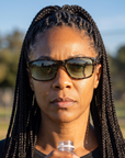 Woman, 37, wearing Peppers Gaucho sunglasses in Shiny Tort with G15 Lens, beside an empty park sports field