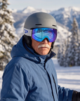 Man, 61, wearing Peppers Glade Runner Pro goggles in Matte Black with Blue Revo, at the top of a chairlift