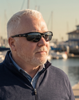 Man, 54, wearing Peppers Grand Slam sunglasses in Matte Black Frame with Smoke Lens, on a marina walkway