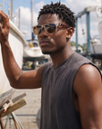 Man, 26, wearing Peppers Lehua sunglasses in Crystal Frame with Tort Temples and Brown Lens, in a boatyard