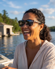 Woman, 33, wearing Peppers Low Rider sunglasses in Matte Grey Gradient Crystal Frame with Smoke Lens, on a lake