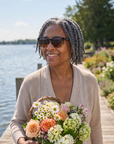 Woman, 59, wearing Peppers Mermaid sunglasses in Shiny Black to Honey Tort Frame with Brown Lens, on a lakeside garden dock