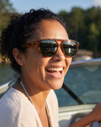 Woman, 33, wearing Peppers Milano sunglasses in Shiny Caramel Tort Frame with G15 Lens, on a lake